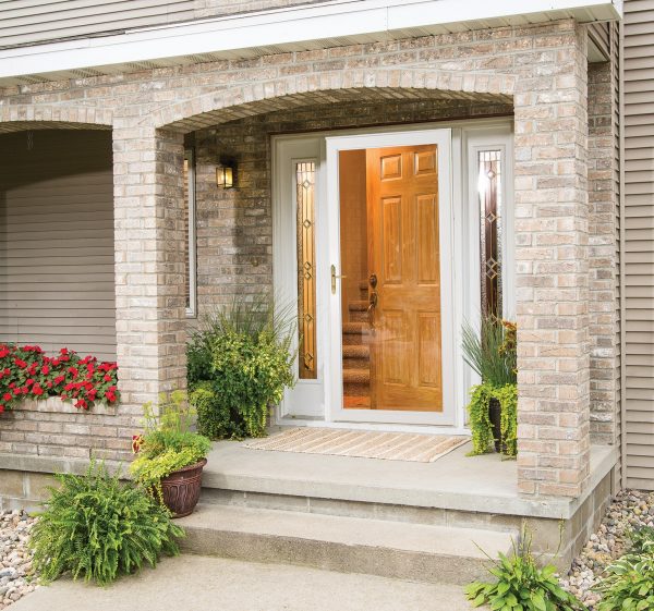 full view storm door on a tan brick house