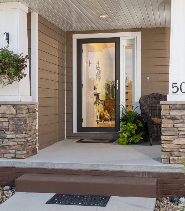 black storm door with sidelite on a house with brown vinyl siding