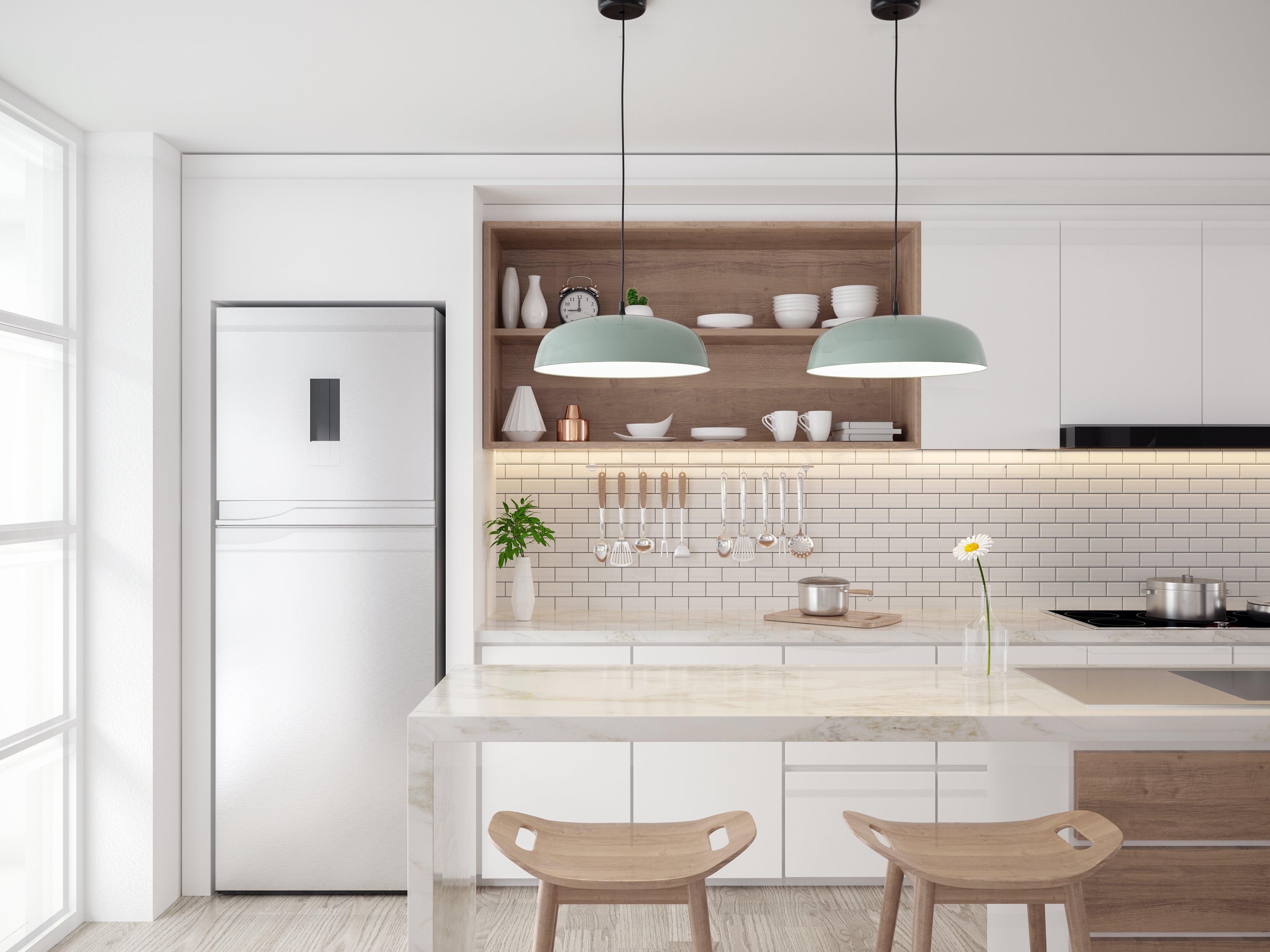 Kitchen with marble countertops and white cabinets and accessories